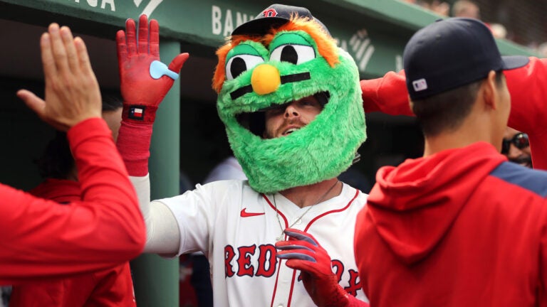Opening Day- Boston Red Sox shortstop Trevor Story (10) wears a Wally Red Sox mascot head that he was adorned with at the Sox dugout after hitting a 3-run 1st inning homer.