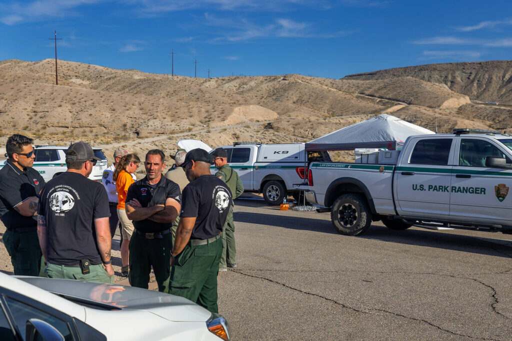 National Park Service Firefighters and others debrief in the parking lot of the White Rock Cany ...