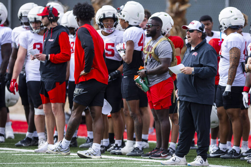 UNLV defensive coordinator Paul Guenther, right, yells from the sidelines during football sprin ...