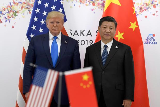 President Donald Trump, left, poses for a photo with Chinese President Xi Jinping