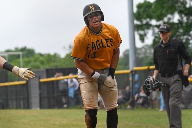 Northeast’s Chase McLaughlin celebrates scoring a run against Chesapeake during...