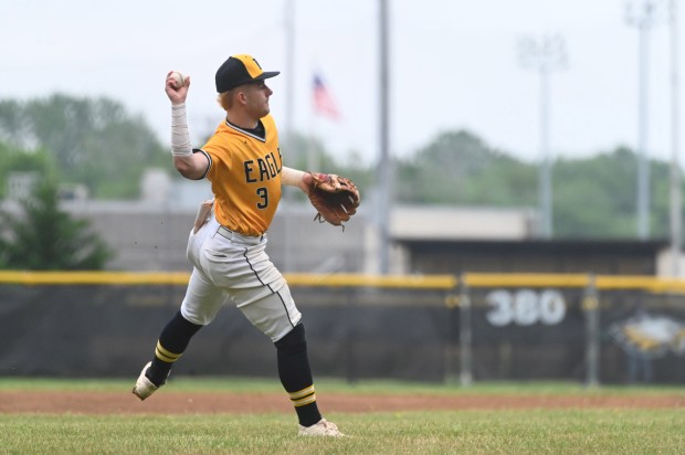 Northeast’s Carter Schreiber throws across the diamond to force out...