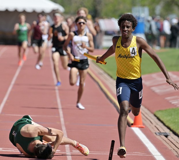 Northfield's Ayuub Hassan, right, passes Mountain Vista's Ben Anderson at the finish line to win the Class 5A boys 4x800 meter relay in the CHSAA state track and field championships at Jeffco Stadium in Lakewood on Thursday, May 15, 2025. (Photo by Hyoung Chang/The Denver Post)
