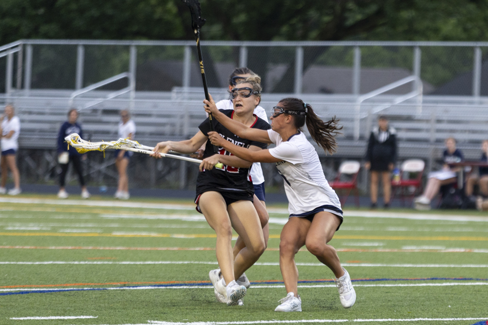 Graceyn Brown evades the defensive efforts of Rita Yost during...