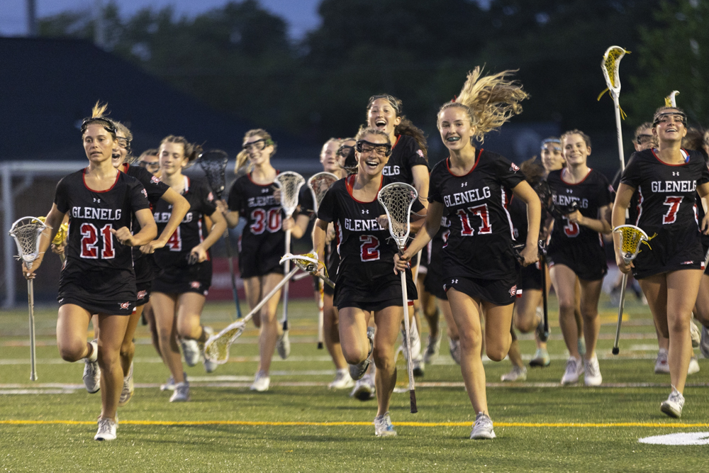 Glenelg players run off the field together after winning a...