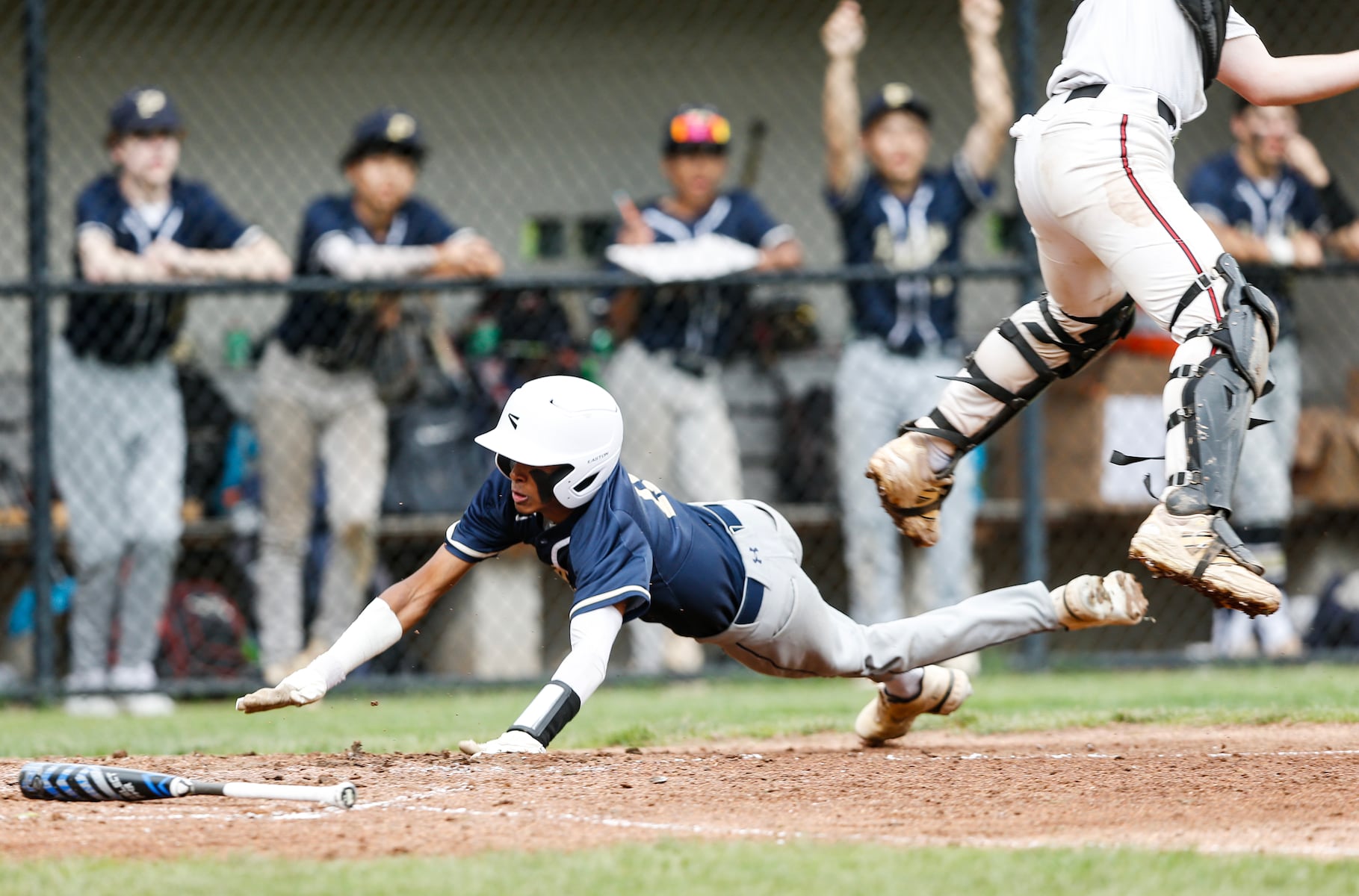Jaden Heble (11) of Peddie slides and avoids Jacob Lillienthal (9) of Hun to score during the Prep A semifinal baseball game between Hun and Peddie at The Hun School of Princeton in Princeton, NJ on 5/18/25.