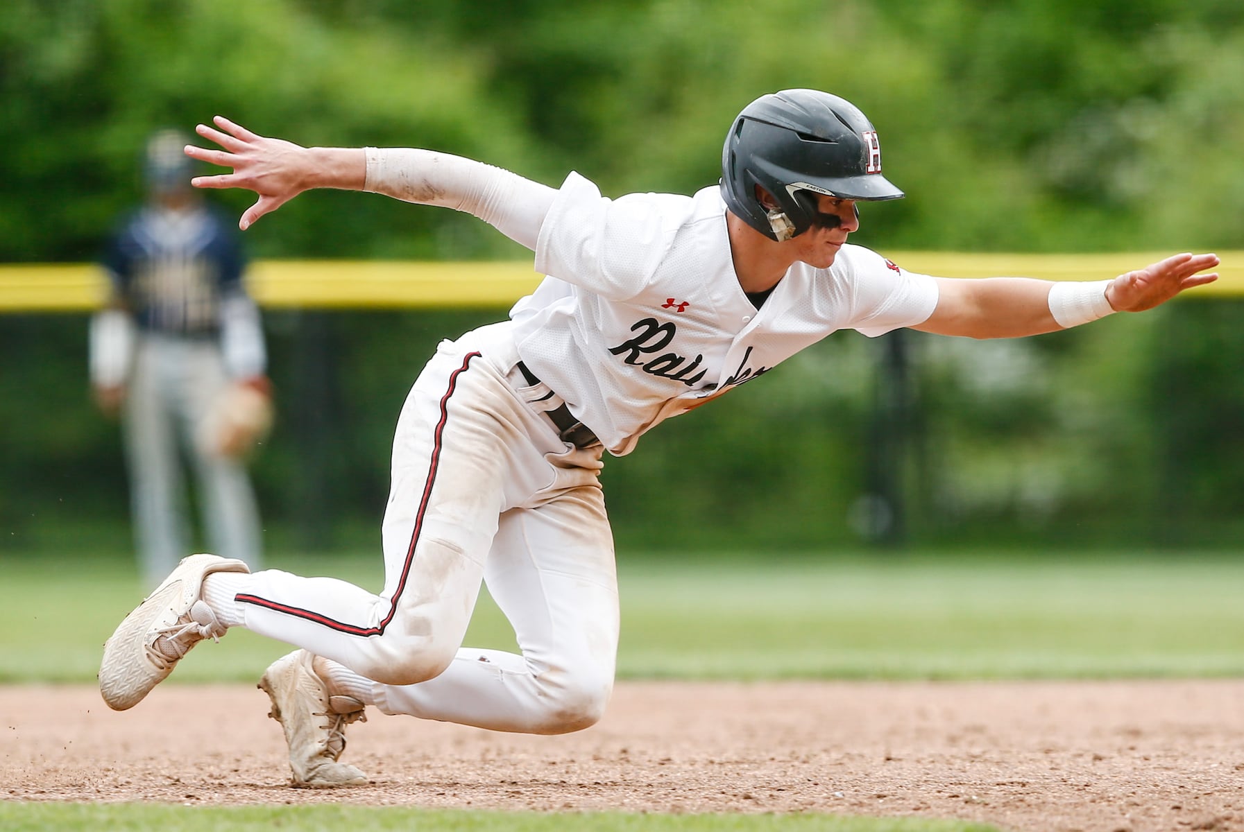 John Rossman (4) of Hun dives back to first base on a pickoff attempt during the Prep A semifinal baseball game between Hun and Peddie at The Hun School of Princeton in Princeton, NJ on 5/18/25.