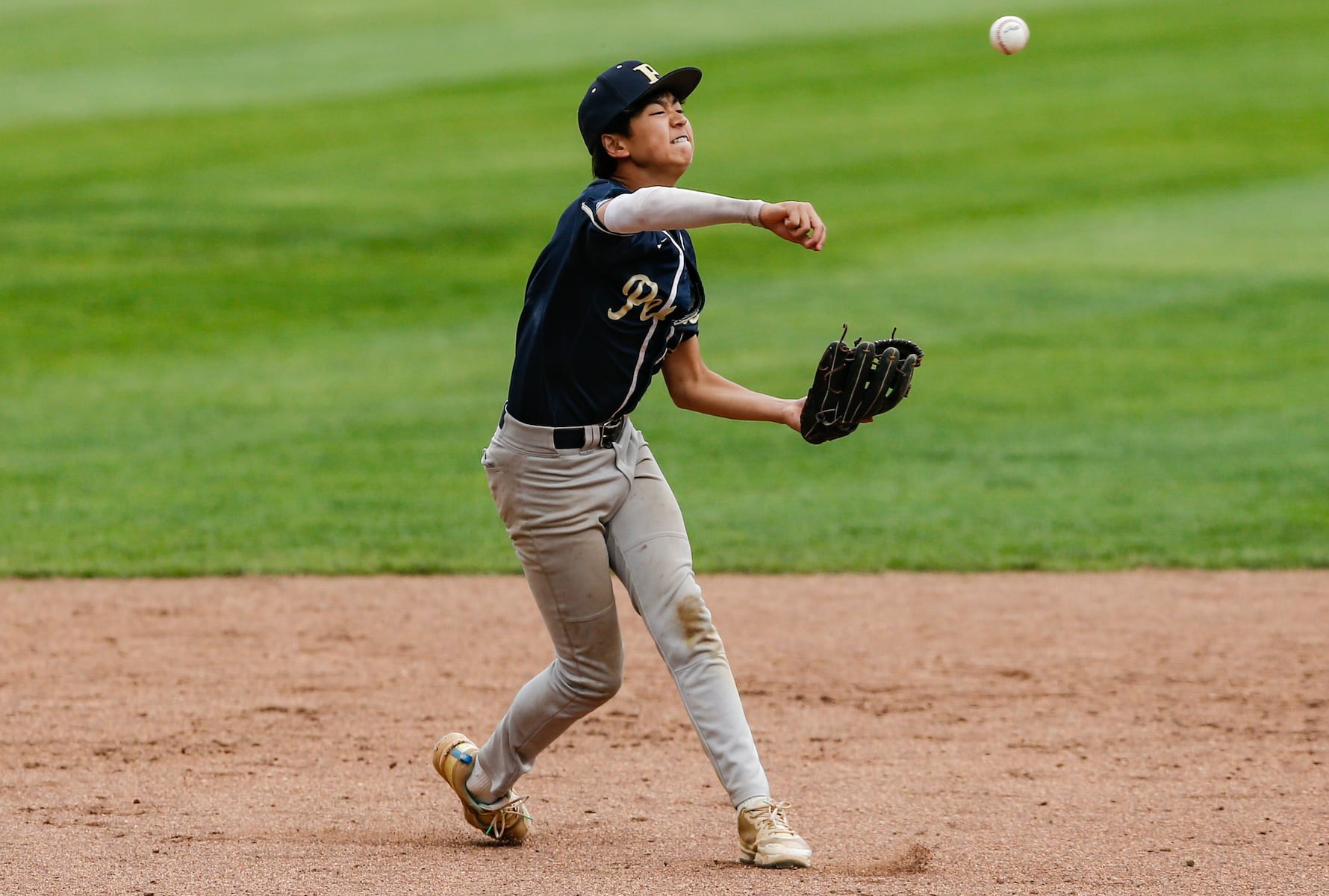 Haruo Narita (8) of Peddie fields a ground ball and fires to first for the out during the Prep A semifinal baseball game between Hun and Peddie at The Hun School of Princeton in Princeton, NJ on 5/18/25.
