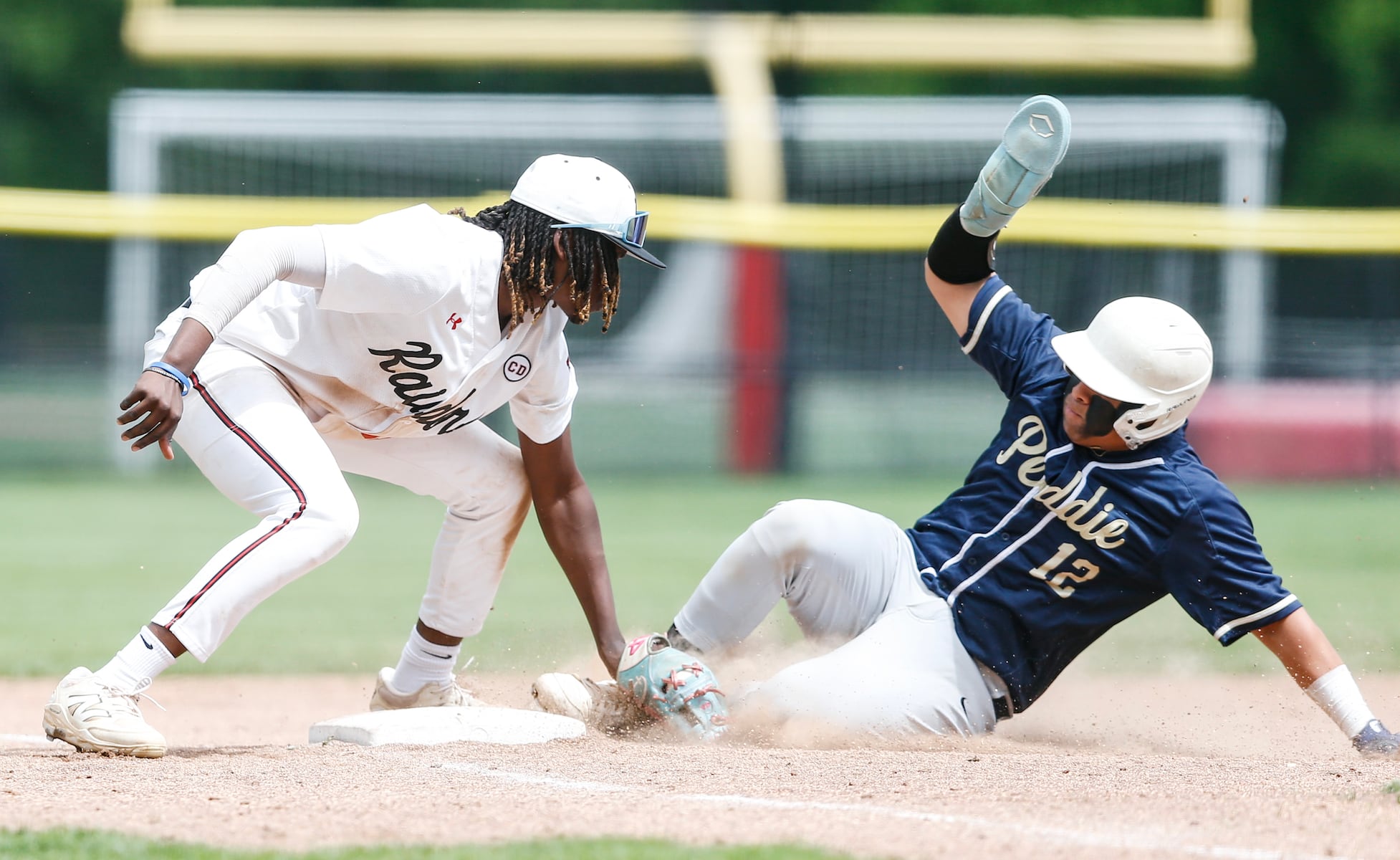 TJ Tift (11) of Hun tags out Eduard Fernandez (12) of Peddie at third base during the Prep A semifinal baseball game between Hun and Peddie at The Hun School of Princeton in Princeton, NJ on 5/18/25.