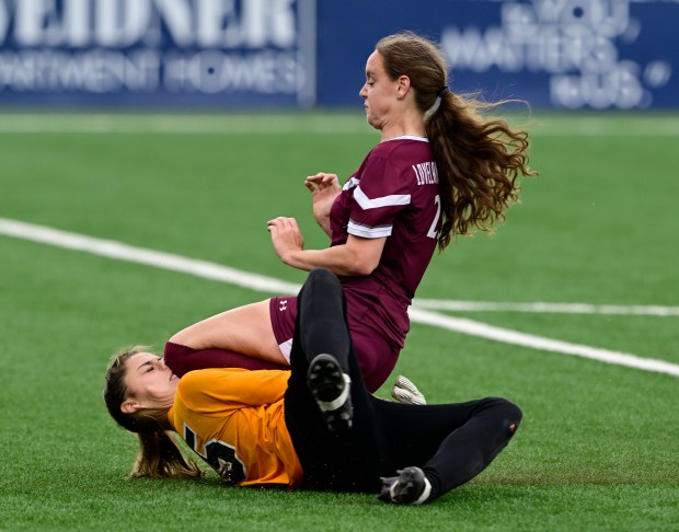 Flatirons Academy goalkeeper, Sydnie Mangel, left, takes a knee to her face from Kaelyn Doan (23), Loveland Classical in the first half of the girls 2A state soccer championship game at Weidner Field in Colorado Springs, Colorado on Wednesday, May 21, 2025. Mangel was injured on the play and was taken off the field with help of trainers and coaches. (Photo by Andy Cross/The Denver Post)