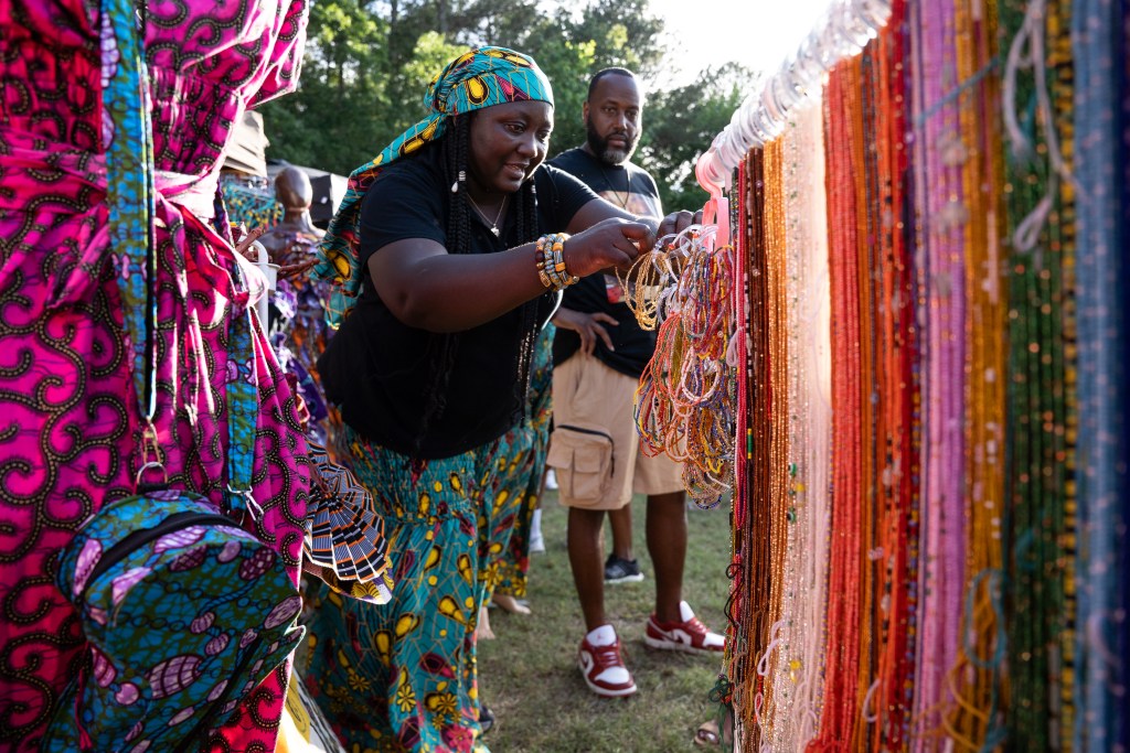 Akosua Wright, the owner of Motherland Authentic, assists a customer during the 55th Annual Bimbé Cultural Arts Festival. Photo by Angelica Edwards.