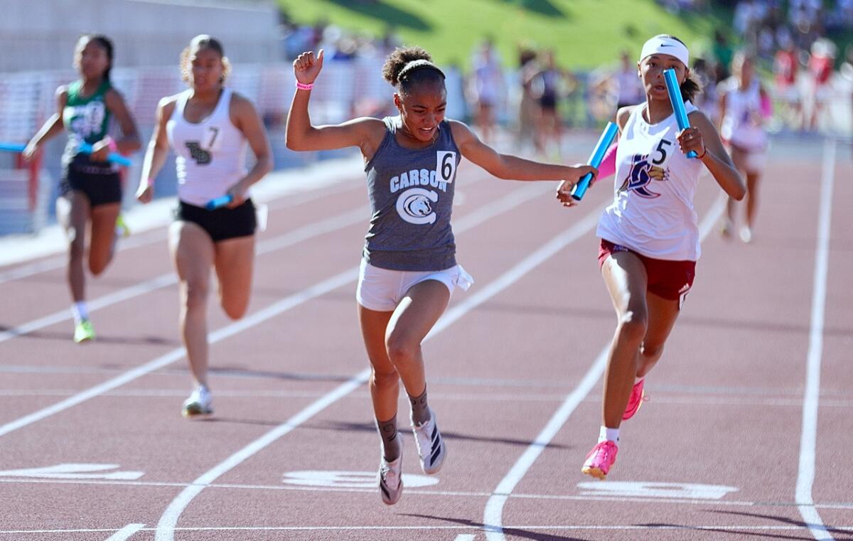 Carson 4x100-meter relay anchor runner Christina Gray crosses the finish line.
