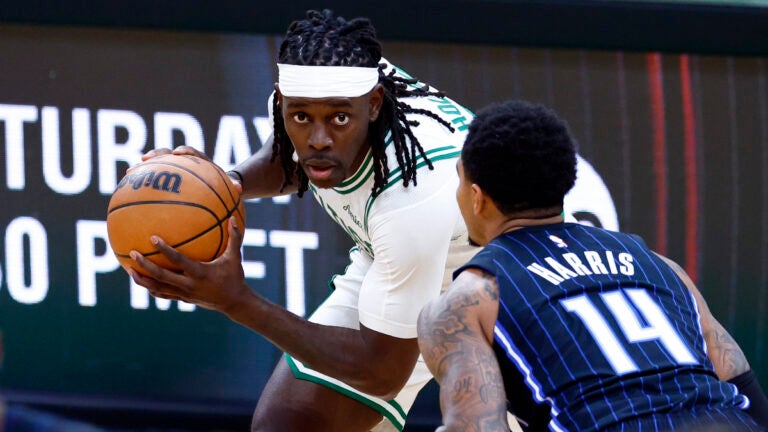 Boston Celtics guard Jrue Holiday (4) goes up against Orlando Magic guard Gary Harris (14) during the fourth quarter in game one of the NBA Eastern Conference playoffs against the Orlando Magic at TD Garden. (Danielle Parhizkaran/Globe Staff)