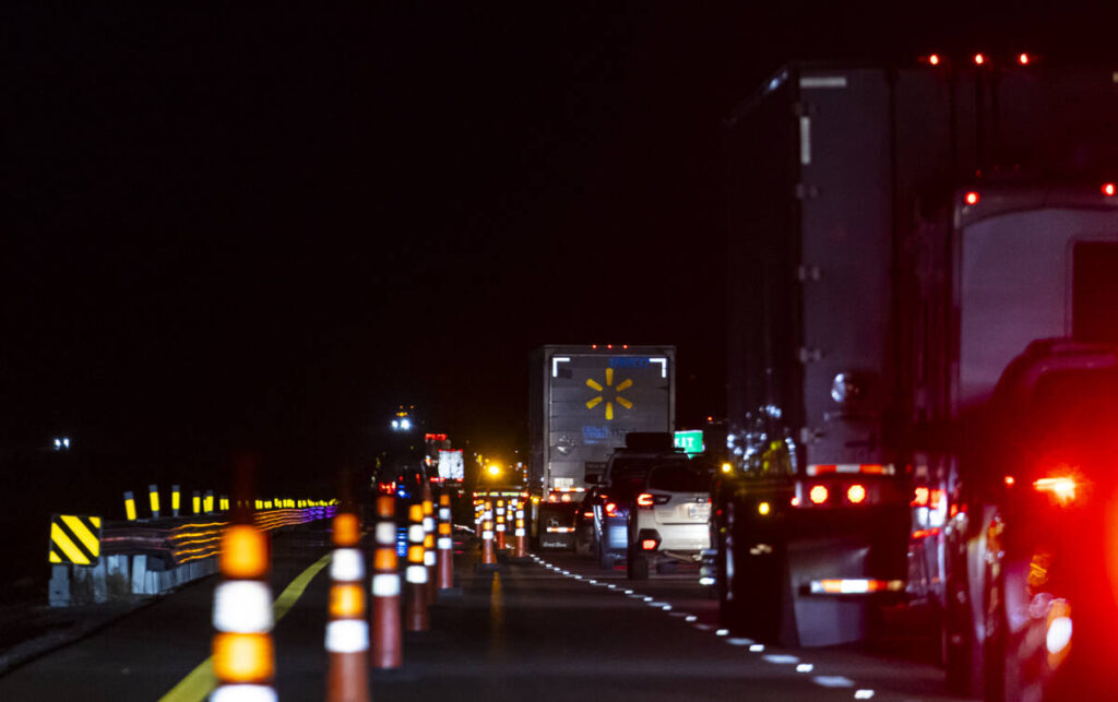 Traffic is diverted off the highway as Nevada Highway Patrol officers investigate the scene of ...