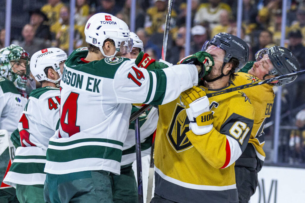 Golden Knights right wing Mark Stone (61) takes a punch to the face from Minnesota Wild center ...