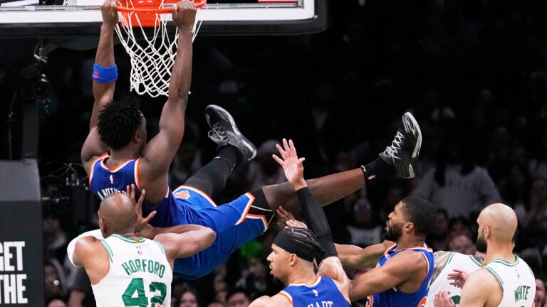 Knicks forward OG Anunoby hangs from the rim after dunking against the Celtics during the second half of Game 1 of their second-round playoff series Monday, May 5, 2025, in Boston.