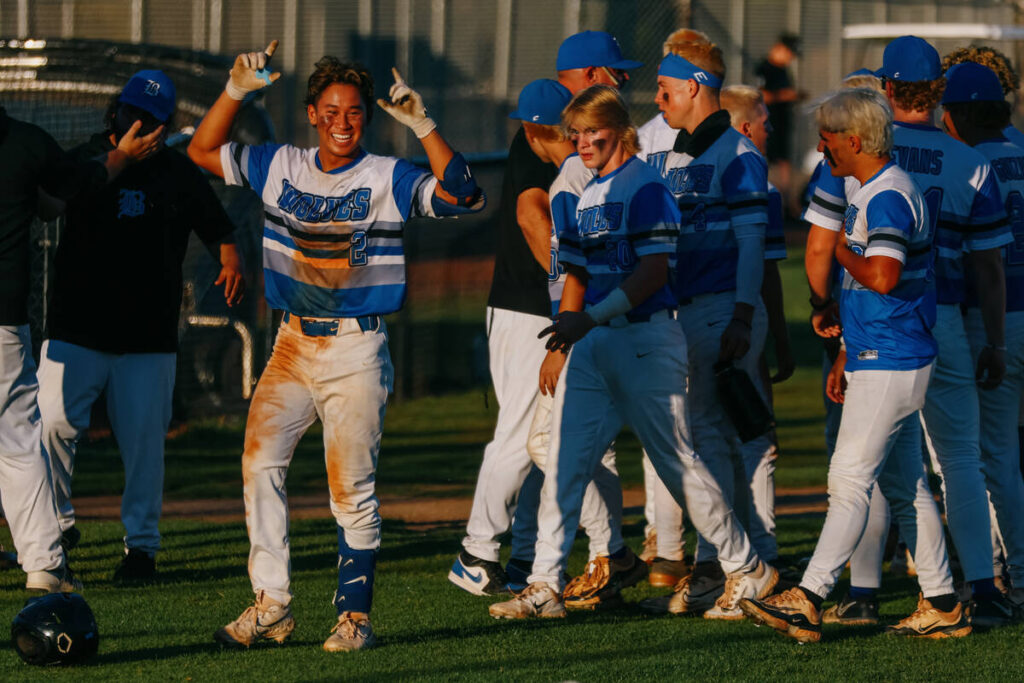 Basic’s Troy Southisene, left, celebrates with his team after his brother Tate Southisen ...