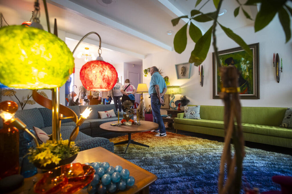 People walk through the living room of a 1964 Marquis-model Paradise Palms home seen during a t ...