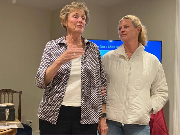 Bonnie Williams, left, niece of World War II hero Robert E. Coulter Jr., of La Grange, talks about his life and sacrifice during a May 22 program at the La Grange Area Historical Society while being joined by her daughter Jennifer Tuerk. (Hank Beckman/Pioneer Press)
