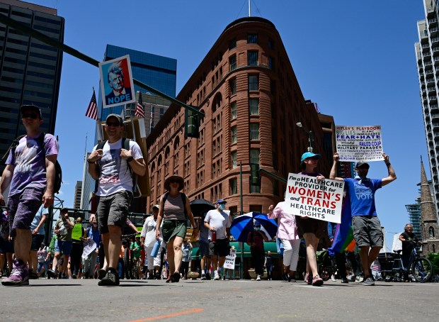"No Kings" protesters march up 17th Avenue at Broadway in...