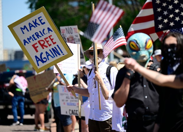 Protesters line North Lincoln Street across from the Capitol building...