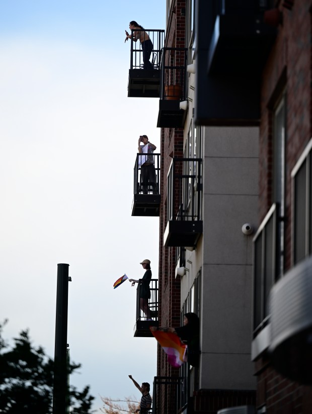 Folks step out onto their balconies at 8th Avenue and...