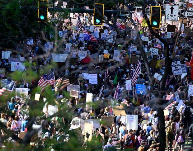 "Ice Out, Stop the Deportations" protesters march up Lincoln Street...