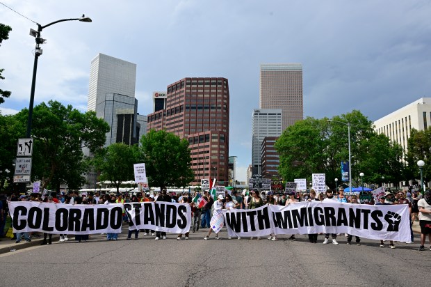 "Ice Out, Stop the Deportations" protesters line up along Lincoln...