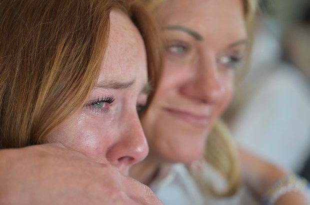 Leora Holmes, 13, left, gets a hug from her mother, Heather Holmes, during visitation services for Raymond Farris Chambers at Fairmount Funeral Home in Denver on June 18, 2025. (Photo by RJ Sangosti/The Denver Post)