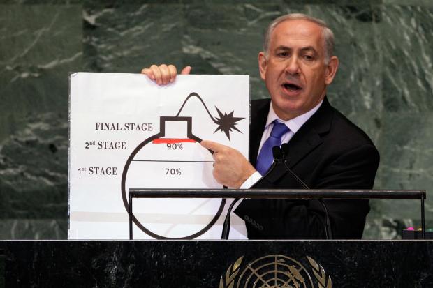 FILE – Israeli Prime Minister Benjamin Netanyahu shows an illustration...