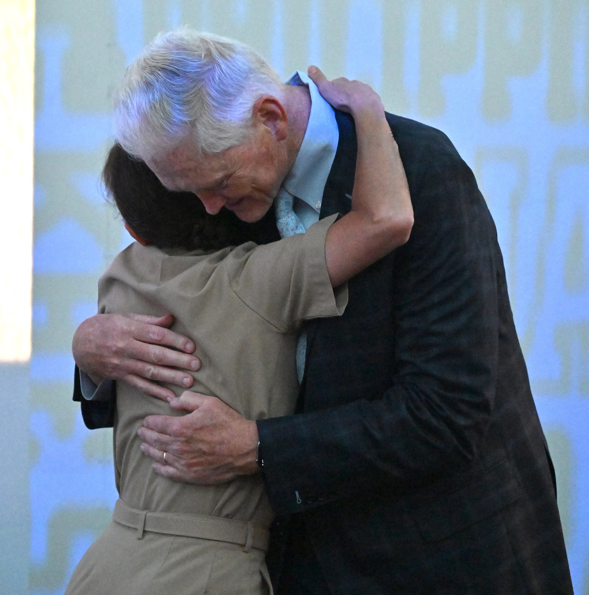 Outgoing Navy Athletic Director Chet Gladchuk hugs USNA Superintendent Vice Admiral Yvette Davids. Outgoing Navy Athletic Director Chet Gladchuk said his goodbyes to staff today and introduced new Navy athletic director Michael Kelly during an event at academy. (Paul W. Gillespie/Staff)