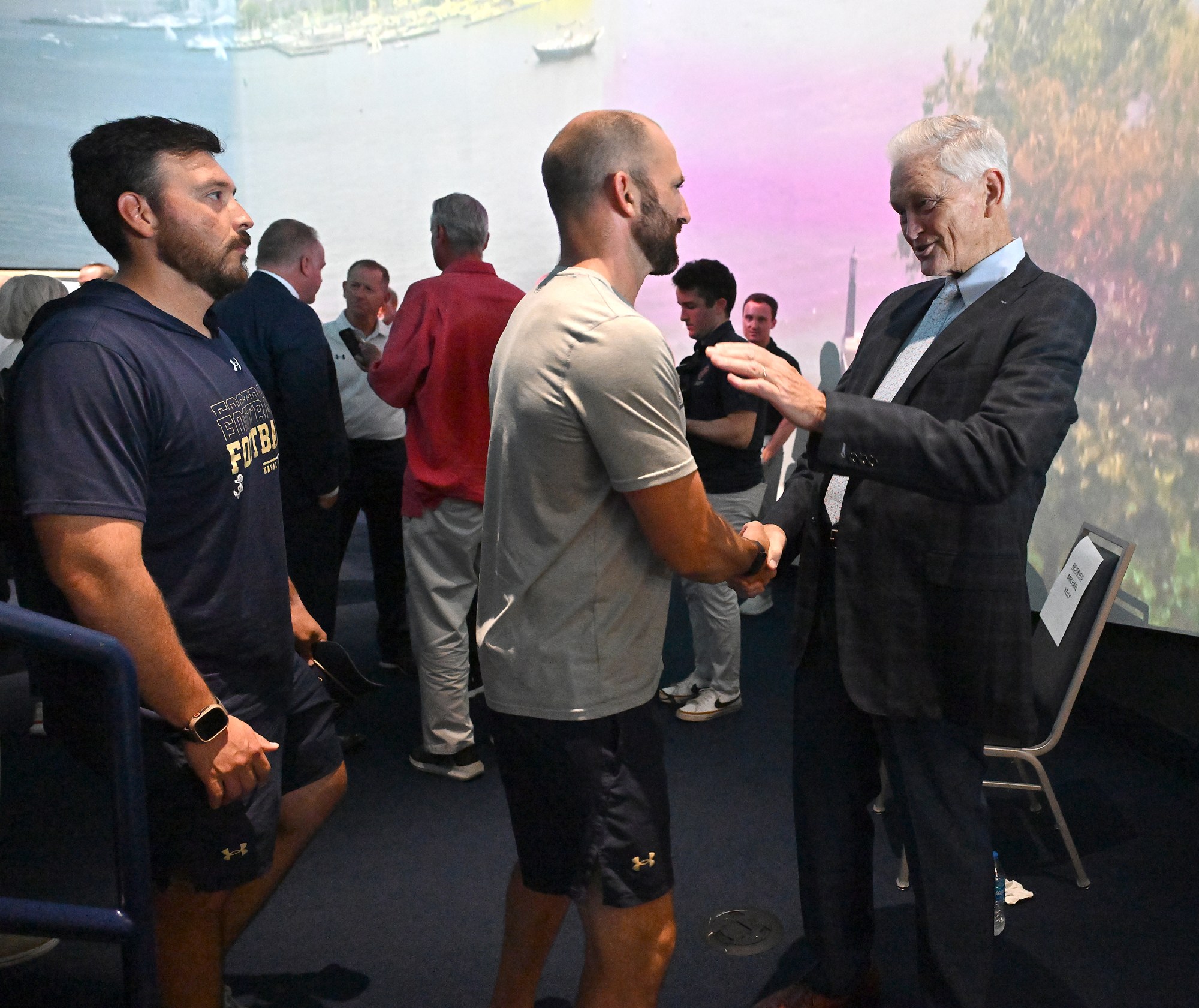 Outgoing Navy Athletic Director Chet Gladchuk, right, says goodbye to staff. Outgoing Navy Athletic Director Chet Gladchuk said his goodbyes to staff today and introduced new Navy athletic director Michael Kelly during an event at academy. (Paul W. Gillespie/Staff)
