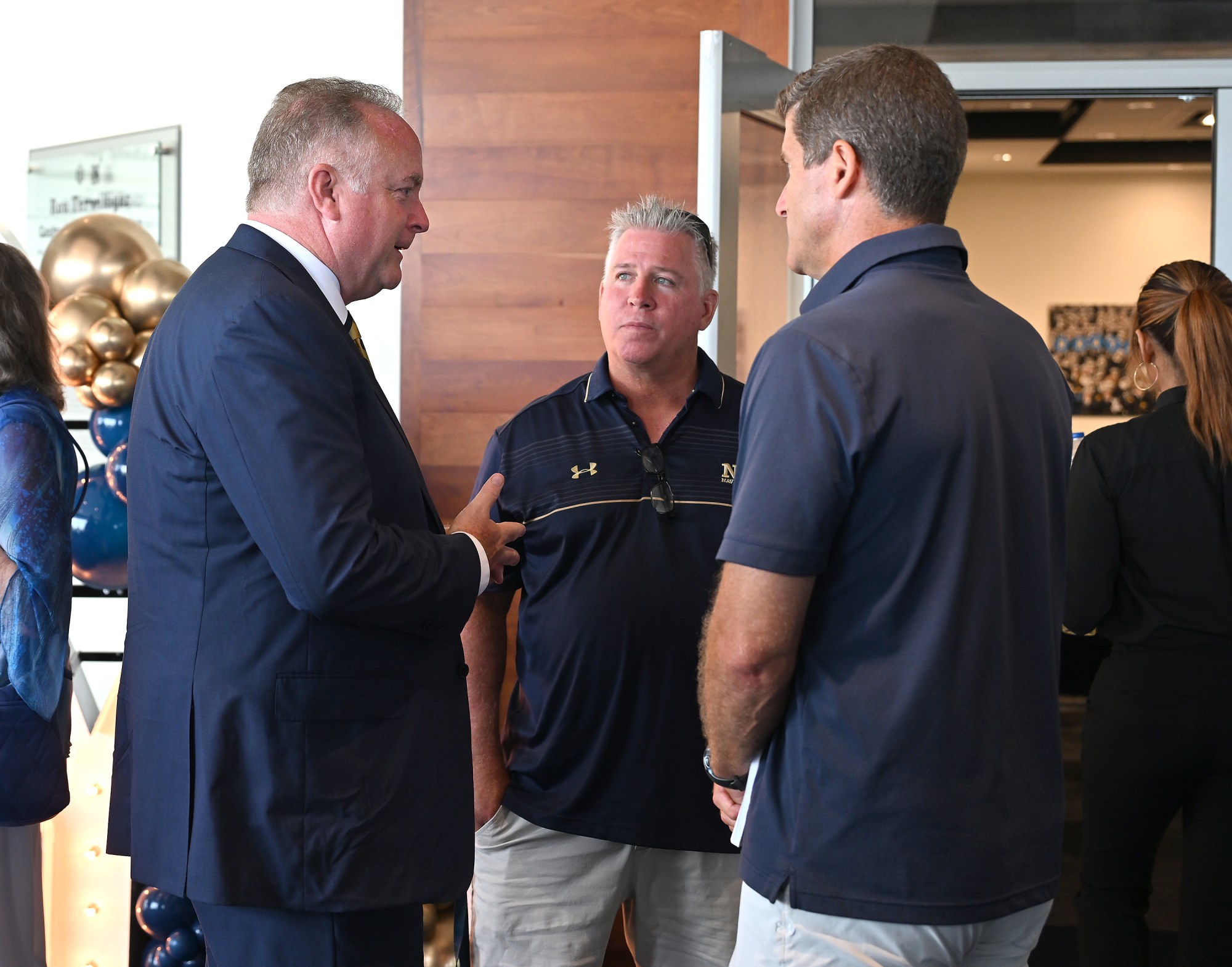 New Athletic Director Michael Kelly speaks to people during a reception. Outgoing Navy Athletic Director Chet Gladchuk said his goodbyes to staff today and introduced new Navy athletic director Michael Kelly during an event at academy. (Paul W. Gillespie/Staff)