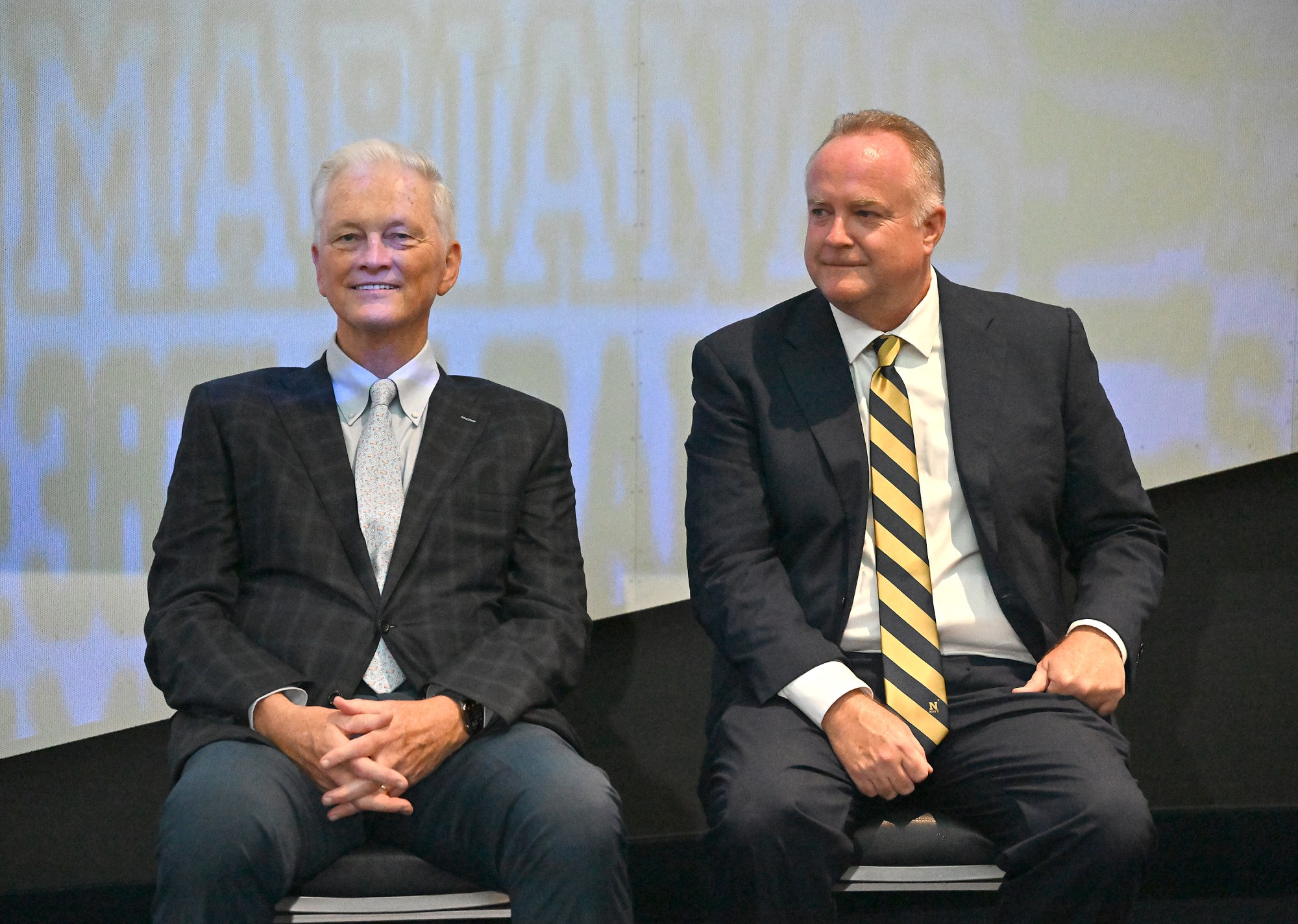 Outgoing Navy Athletic Director Chet Gladchuk and new AD Michael Kelly wait to speak. Outgoing Navy Athletic Director Chet Gladchuk said his goodbyes to staff today and introduced new Navy athletic director Michael Kelly during an event at academy. (Paul W. Gillespie/Staff)