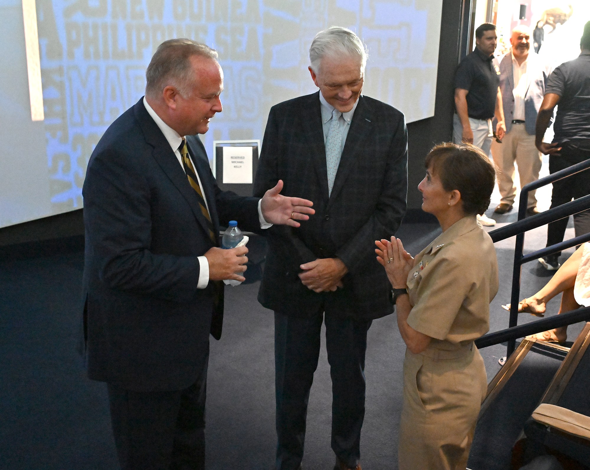 New Athletic Director Michael Kelly, left, speaks with outgoing AD Chet Gladchuk and USNA Superintendent Vice Admiral Yvette Davids. Outgoing Navy Athletic Director Chet Gladchuk said his goodbyes to staff today and introduced new Navy athletic director Michael Kelly during an event at academy. (Paul W. Gillespie/Staff)