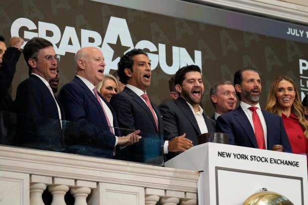 GrabAGun board member Donald Trump, Jr., second from right, CEO Marc Nemati, fourth from right, and others ring the opening bell at the New York Stock Exchange