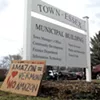 Signs outside the Essex town offices during a rally against Amazon's proposal
