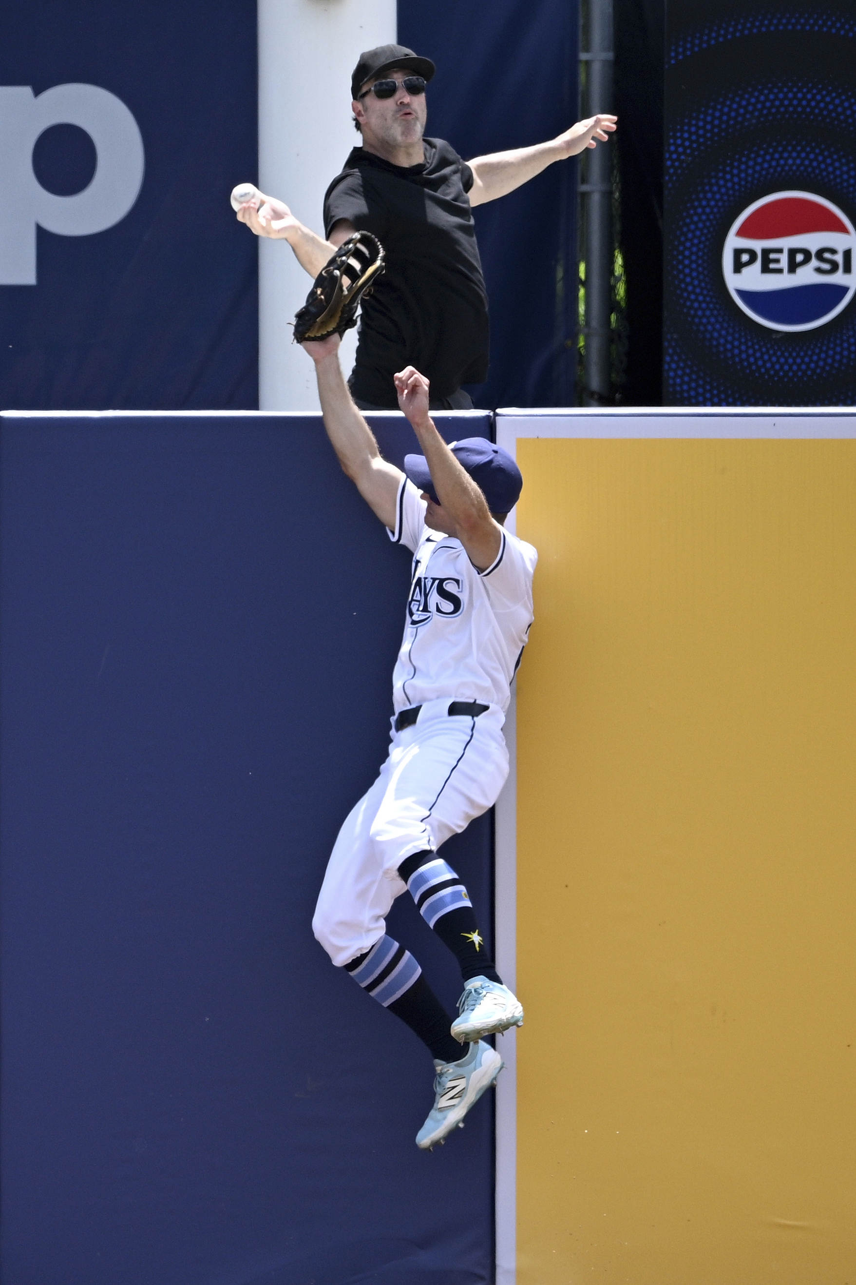 A fan reaches for a home run hit by Baltimore...