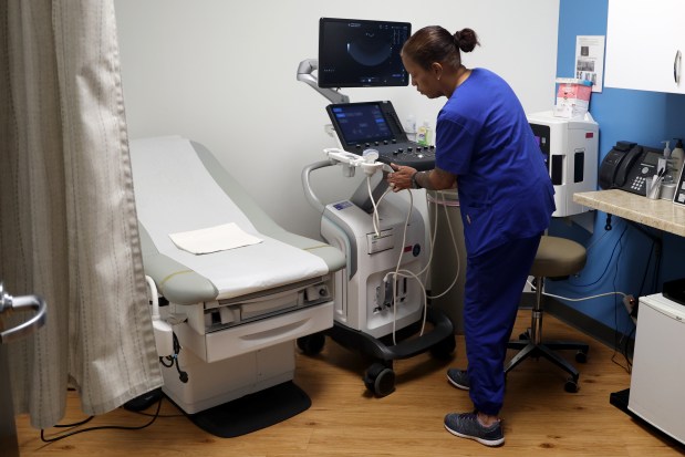 Lead reproductive assistant Martha Tovar prepares an exam room at the start of the day at the Planned Parenthood Englewood Health Center on Feb. 13, 2025. (Antonio Perez/Chicago Tribune)