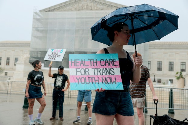 A protester holds a sign in support of gender-affirming care for transgender youth outside of the U.S. Supreme Court Building on June 18, 2025, in Washington. Advocates organized a rally in response the U.S. Supreme Court's ruling in US v. Skrmetti, in which the justices ruled to uphold state bans on gender-affirming medical care for transgender youth. (Anna Moneymaker/Getty)