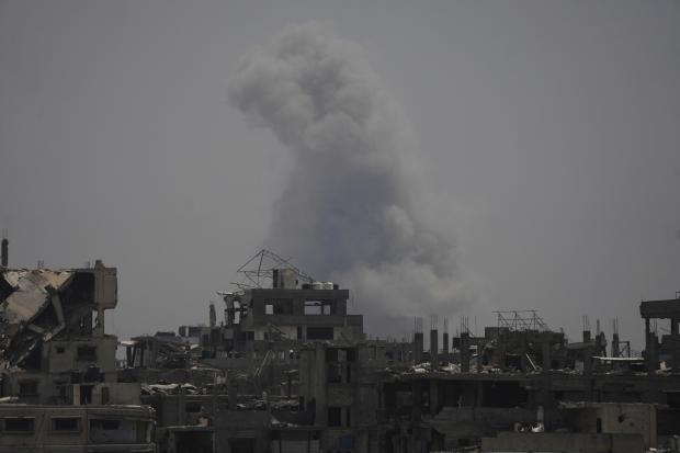 Smoke rises following an Israeli airstrike in northern Gaza Strip,...
