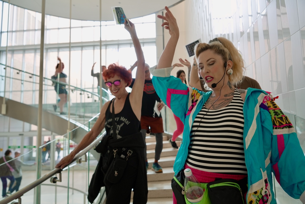 mall walkers dramatically descend a staircase