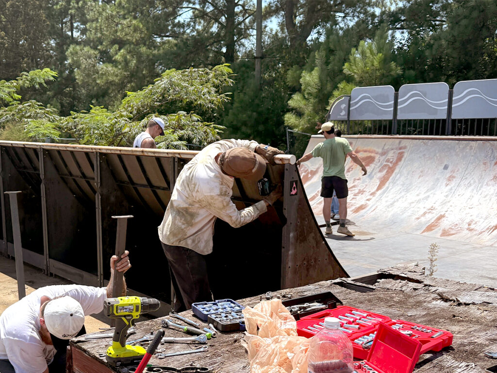 Volunteers, including Mark Hanley (center) disassemble a mini ramp on August 9, 2025, in Durham.