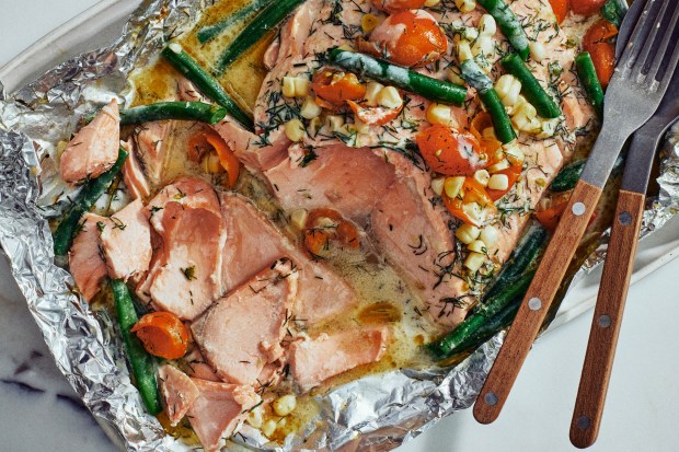 Coconut-dill salmon with green beans and corn. Yewande Komolafe wrote this recipe for a summer dinner party, feeding six to eight people with utterly delicious ease. Food styled by Susie Theodorou. (Alex Lau/The New York Times)