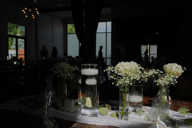 Sunlight falls on table decorations as guests arrive before a...
