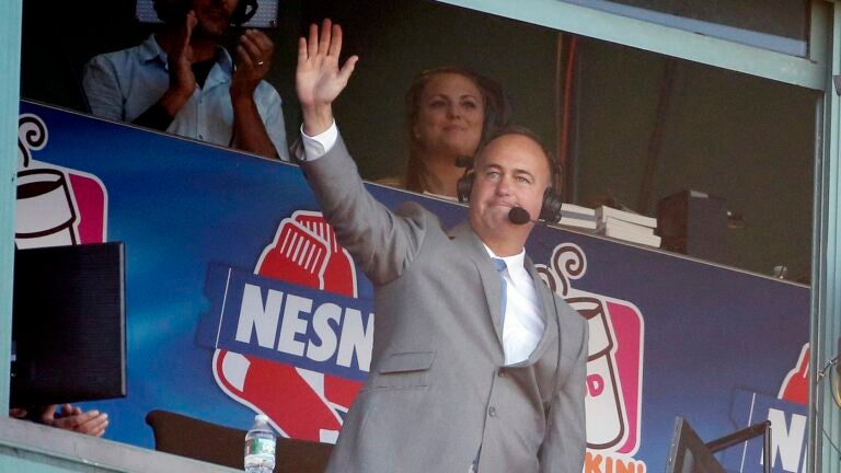 Sports announcer Don Orsillo waves from the broadcast booth following a video tribute during the eighth inning of a baseball game between the Boston Red Sox and the Baltimore Orioles in Boston, Sunday, Sept. 27, 2015.