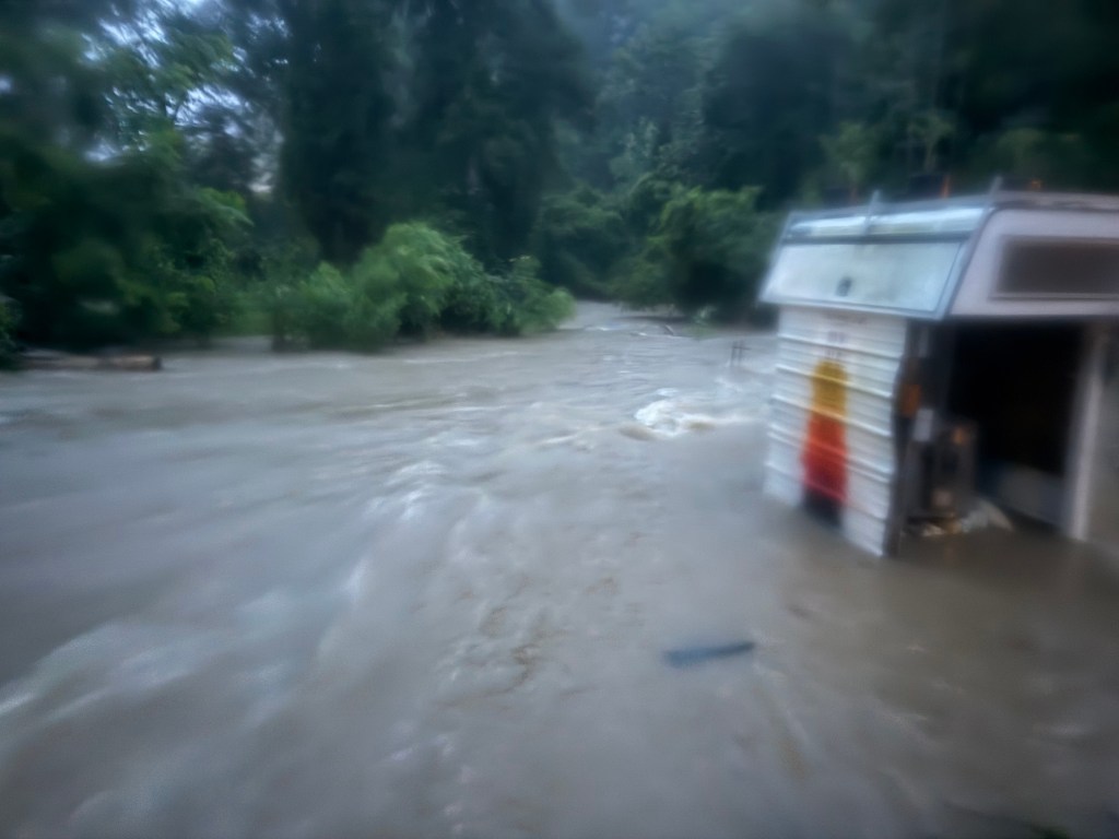 Horton and Greganti’s backyard on July 6, with floodwaters surrounding Horton’s kiln shed.