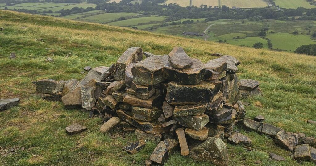 Stone stacks litter pristine trails. A grumpy hiker is kicking back
