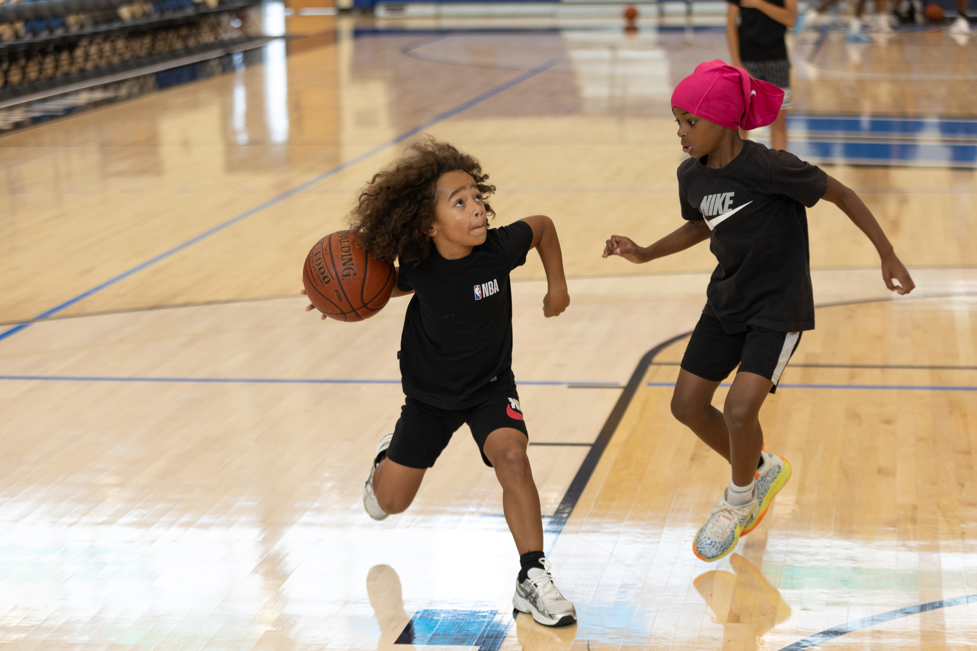 Tristan Johnson, 10, left, drives to the basket against Chaz Strand, 10, during the Unity N Hoops Skills Camp event at the APG Federal Credit Union Arena at Harford Community College in Bel Air, MD. (Haldan Kirsch/Freelance)