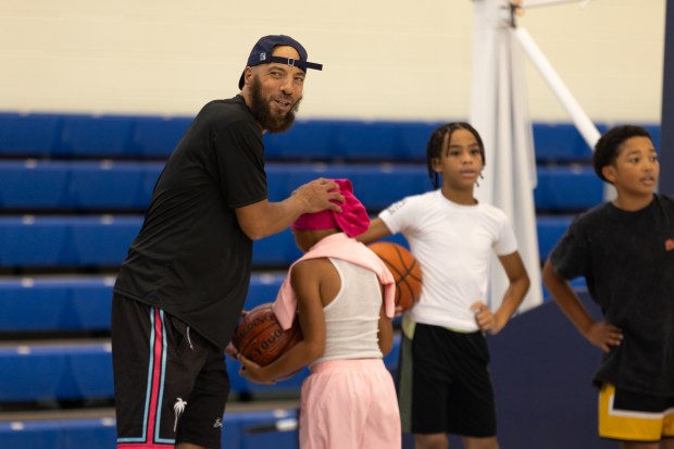 Skills Camp coach JR Clark encourages Kingston Burke, 9, during a fast break drill at the Unity N Hoops Skills Camp event at the APG Federal Credit Union Arena at Harford Community College in Bel Air, MD. (Haldan Kirsch/Freelance)